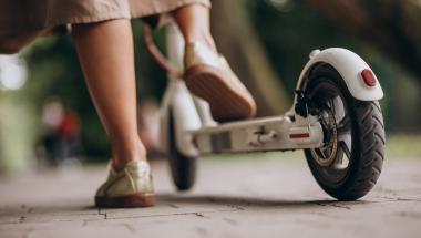 young-woman-riding-scooter-in-park-feet-close-up.jpg